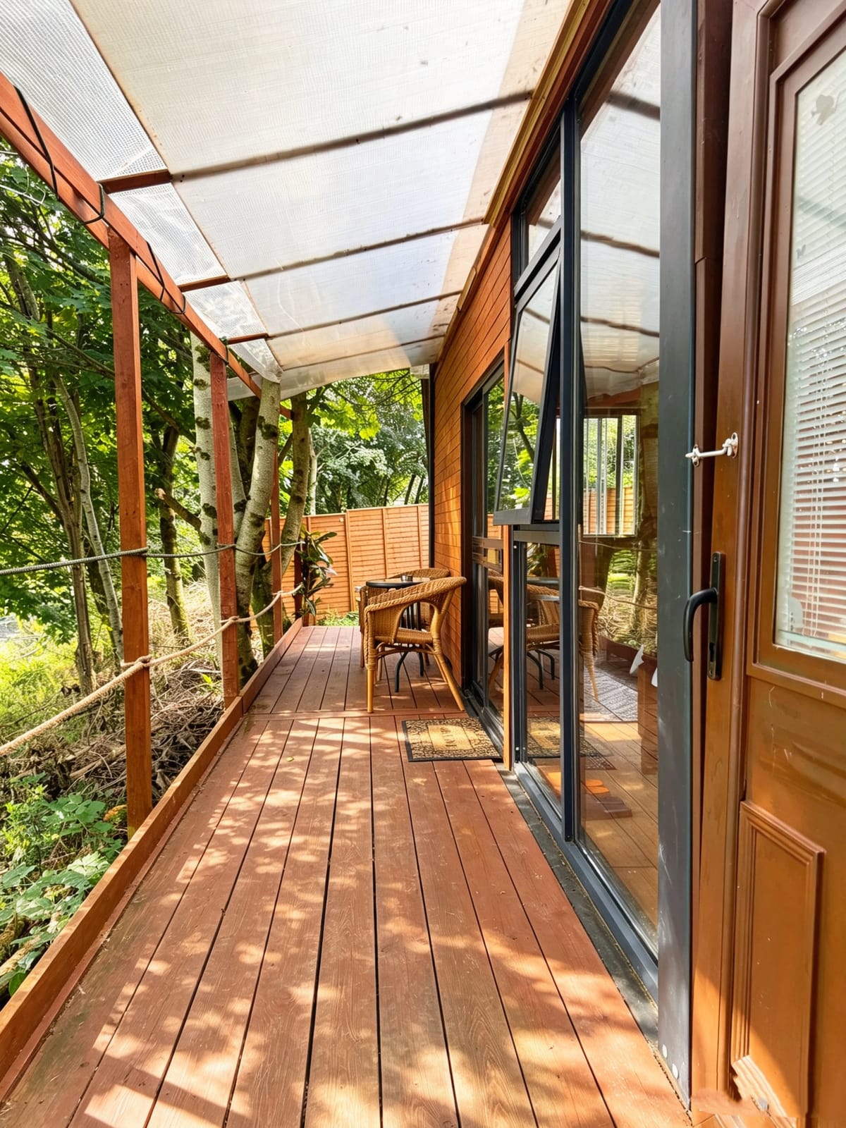 Covered woodland deck beside Farm Cabin